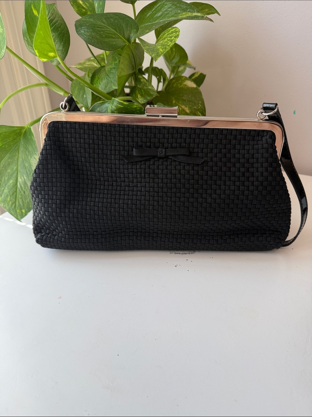 The SAK Black Woven Frame Clutch/Handbag with Bow Accent